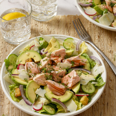 Salmon and Avocado Caesar Salad / JillHough.com A classic Caesar embellished with hunks of salmon and avocado, plus cucumber, radishes, and onion. It ticks all the boxes and more. #salmon #caesar #caesarsalad #avocado #dinnersalad #mealsalad #fish #fishandseafood #ceasarsalad #ceasar