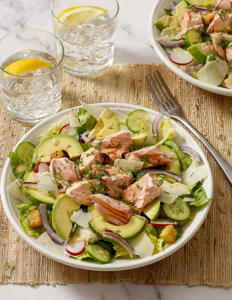 Salmon and Avocado Caesar Salad / JillHough.com A classic Caesar embellished with hunks of salmon and avocado, plus cucumber, radishes, and onion. It ticks all the boxes and more. #salmon #caesar #caesarsalad #avocado #dinnersalad #mealsalad #fish #fishandseafood #ceasarsalad #ceasar