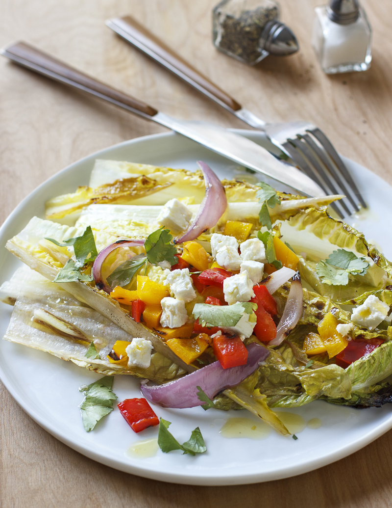 Grilled Salad with Romaine, Peppers, Feta, and Cilantro / JillHough.com The slightly bitter nature of romaine is nicely complemented by a little charring, and the same is true for endive and radicchio. You can change things up by using one or both of those instead of some or all of the romaine, and also by using different cheeses and herbs. #salad #grilling #grilledsalad #romaine #feta #peppers #cilantro #grilledpeppers