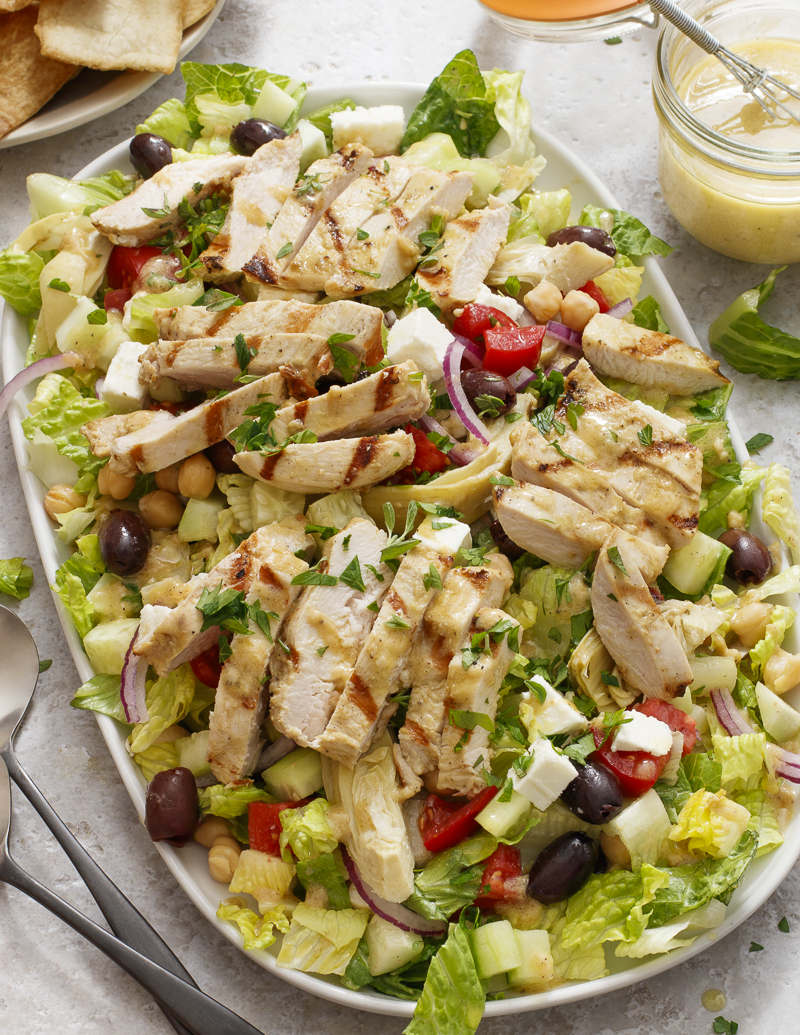 My Big Fat Greek Salad, Chopped and with Chicken / JillHough.com A hearty Greek salad with extras like garbanzos, marinated artichoke hearts, and grilled chicken on top. #greeksalad #dinnersalad #chicken #grilledchicken #tomato #cucumber #fetacheese #garbanzos #olives #salad #bigsalad