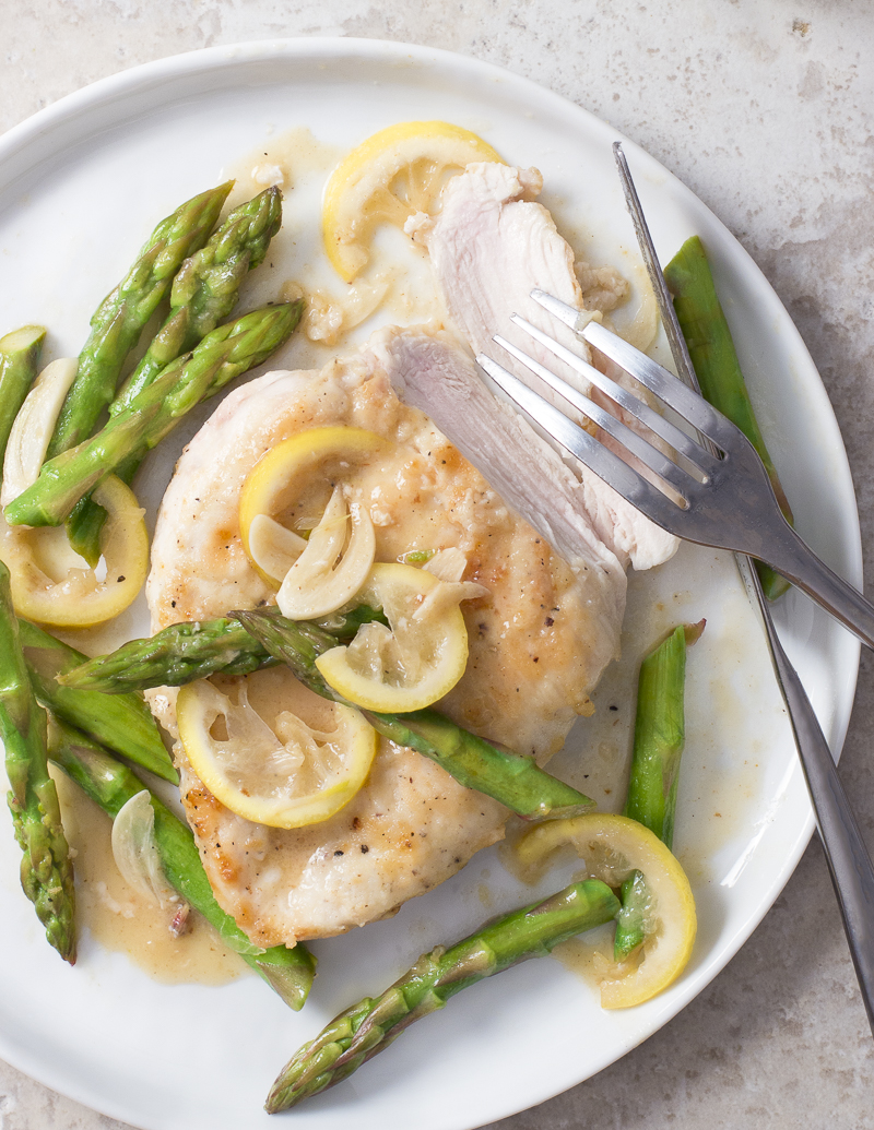 Chicken Paillards with Asparagus, Lemon, and Garlic / JillHough.com This dish featuring pounded chicken breasts is springtime in a skillet, full of light, bright flavors and colors. #chicken #chickencutlet #asparagus #lemon #garlic
