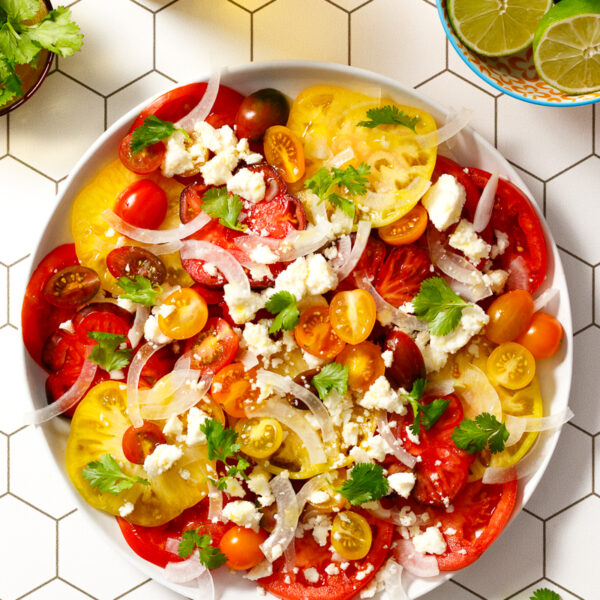 Latin-Inspired Caprese Salad / JillHough.com Keep your cooking interesting with simple swaps. My Latin-Inspired Caprese swaps queso fresco for mozzarella and cilantro for basil. The result—a delicious new way to enjoy an old favorite. #caprese #salad #tomatoes #cilantro #cheese #quesofresco