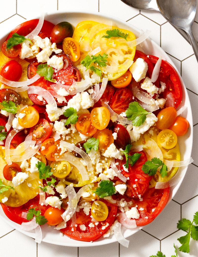 Latin-Inspired Caprese Salad / JillHough.com My Latin-Inspired Caprese swaps queso fresco for mozzarella and cilantro for basil. The result—a delicious new way to enjoy an old favorite. #caprese #salad #tomatoes #cilantro #cheese #quesofresco