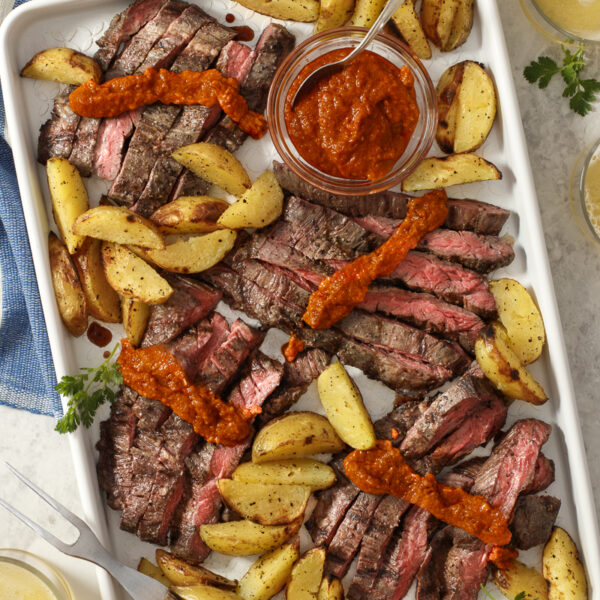 Grilled Skirt Steak and Potatoes with Romesco / JillHough.com A version of this dish—featuring romesco, a smoky, silky, seductive Spanish red pepper sauce—is part of my regular repertoire. Sometimes I do it with salmon instead of steak, and sometimes I roast or pan-sear instead of grilling. But I always use a forkful of potato to wipe up every last bit of the addictive sauce. #skirtsteak #steak #potatoes #steakandpotatoes #meatandpotatoes #romesco #romescosauce #Spanishfood