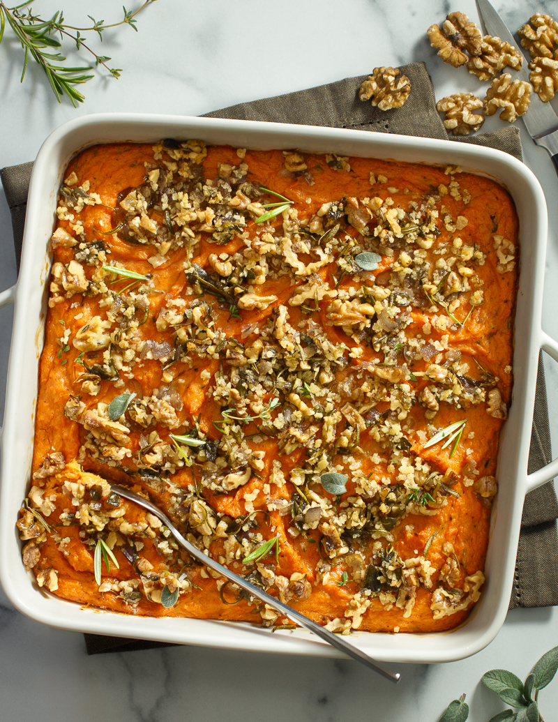 Savory Sweetpotato Casserole with Herbs, Walnuts, and Brown Butter / JillHough.com A moaningly good, definitely savory, herby, creamy inside, crunchy on top casserole. It’s absolutely amazing with Thanksgiving turkey, but unlike marshmallow casserole, you might want it more than once a year—alongside a weekend roast, for example, or a simple weeknight steak, chop, or chicken breast. #sweetpotatoes #sweetpotato #sweetpotatocasserole #herbs #rosemary #thyme #sage #walnuts #brownbutter #Thanksgivingrecipe #holidayrecipe