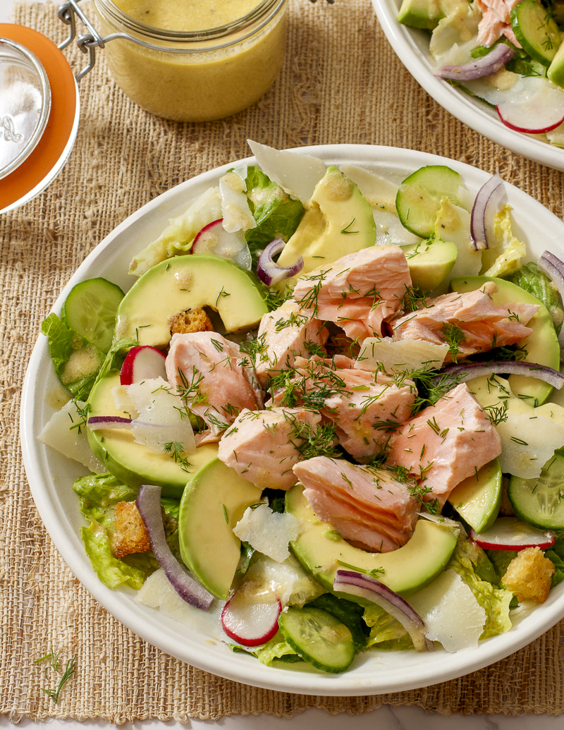 Salmon and Avocado Caesar Salad / JillHough.com A classic Caesar embellished with hunks of salmon and avocado, plus cucumber, radishes, and onion. It ticks all the boxes and more. #salmon #caesar #caesarsalad #avocado #dinnersalad #mealsalad #fish #fishandseafood #ceasarsalad #ceasar