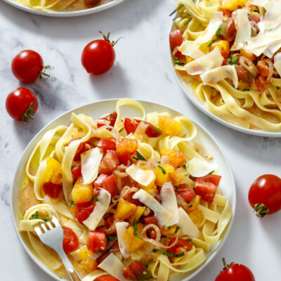 Tons of Tomatoes Fettuccine / JillHough.com This beautifully simple pasta—with tons of tomatoes, shallots, basil, parmesan, and olive oil—is a celebration of peak-season tomatoes. #tomatoes #tomatopasta #freshtomatopasta #summerpasta #summertomatoes #basil #shallots #parmesan #fettuccine #tomatofettuccine