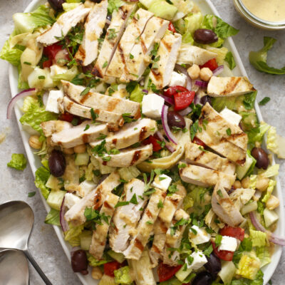 My Big Fat Greek Salad, Chopped and with Chicken / JillHough.com A hearty Greek salad with extras like garbanzos, marinated artichoke hearts, and grilled chicken on top. #greeksalad #dinnersalad #chicken #grilledchicken #tomato #cucumber #fetacheese #garbanzos #olives #salad #bigsalad