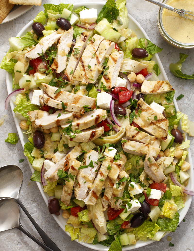My Big Fat Greek Salad, Chopped and with Chicken / JillHough.com A hearty Greek salad with extras like garbanzos, marinated artichoke hearts, and grilled chicken on top. #greeksalad #dinnersalad #chicken #grilledchicken #tomato #cucumber #fetacheese #garbanzos #olives #salad #bigsalad